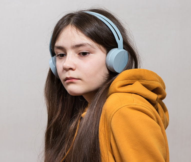 Screenshot 2025-06-15 at 17.12.13 a teenage girl with headphones